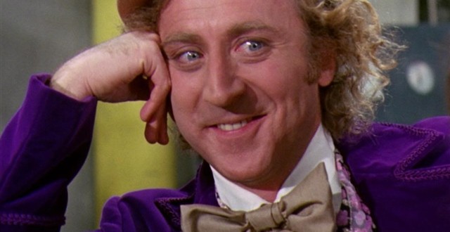 a man in a purple suit and hat