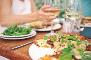 a plate of pizza and wine glasses