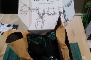 a box with a black and green garment