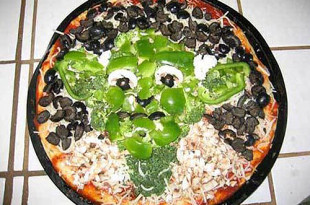 a pizza with green peppers and black beans