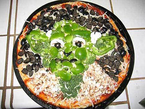 a pizza with green peppers and black beans