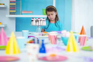 a girl looking at a cake