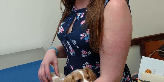 a woman holding a dog