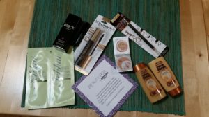 a group of makeup products on a green mat