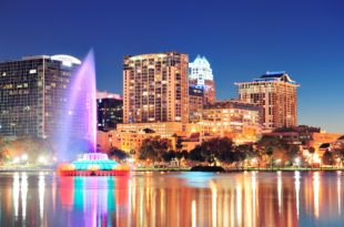 a water fountain in front of a city