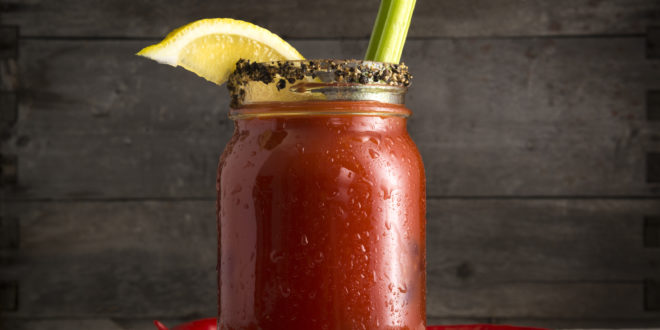 a glass jar with a drink and a lemon on top