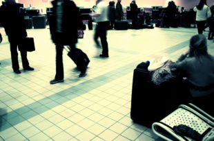 a group of people walking with luggage