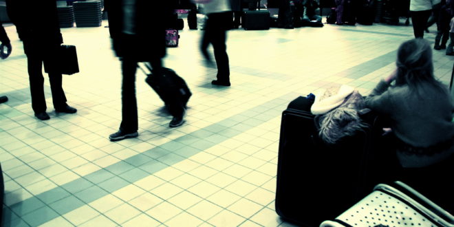 a group of people walking with luggage