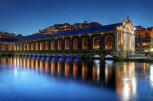 a building with many windows and a body of water