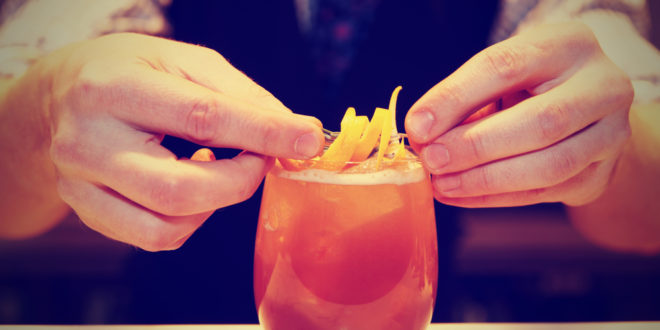 a person's hands making a drink