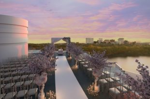 a wedding ceremony on a rooftop overlooking a city