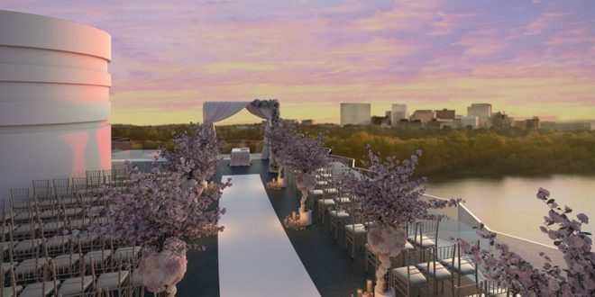 a wedding ceremony on a rooftop overlooking a city