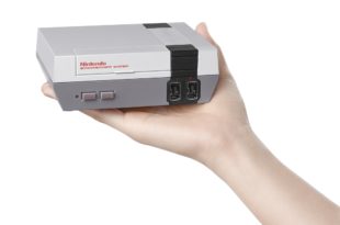 a hand holding a video game console