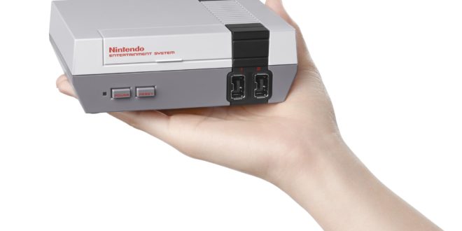 a hand holding a video game console
