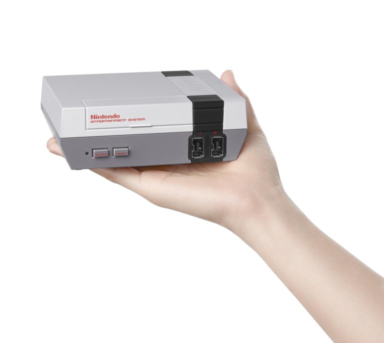 a hand holding a video game console