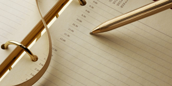 a gold pen on a notebook