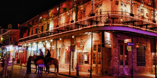 a building with a balcony and a couple of horses