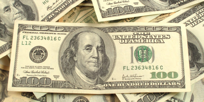 a pile of money with a few hundred dollar bills