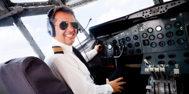 a man in a pilot's cockpit