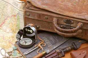 a compass and a suitcase with a map and knife