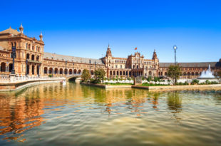 a building with a bridge and a pond