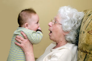 an old woman holding a baby