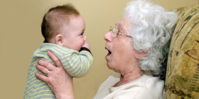 an old woman holding a baby