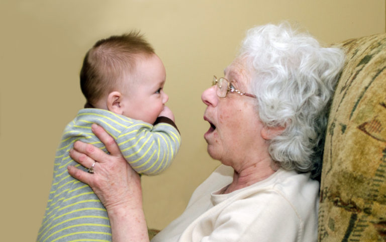 an old woman holding a baby