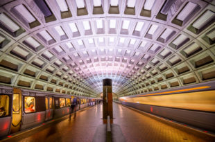 a subway station with a train moving in