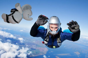 a person skydiving with a stuffed elephant