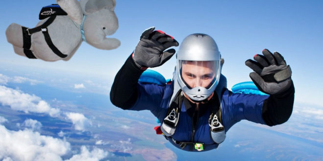 a person skydiving with a stuffed elephant