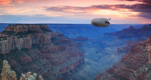 a blimp flying over a canyon
