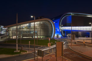 a building with a curved roof and a street light