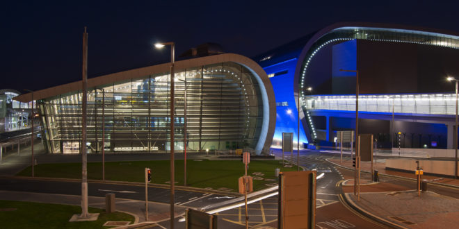 a building with a curved roof and a street light