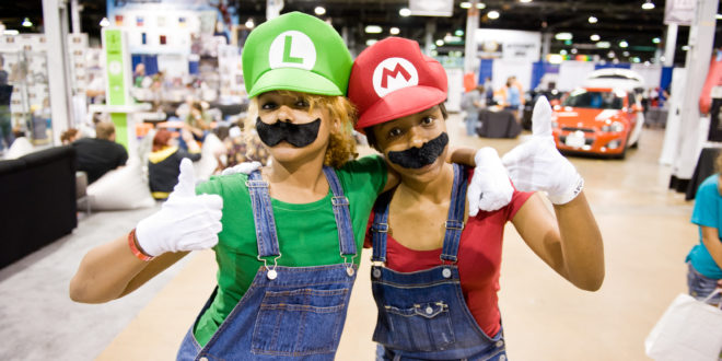 two women wearing clothing and smiling
