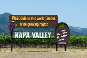 a sign in front of a vineyard