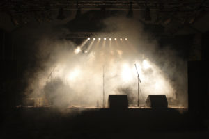 a stage with smoke and lights