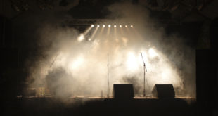 a stage with smoke and lights