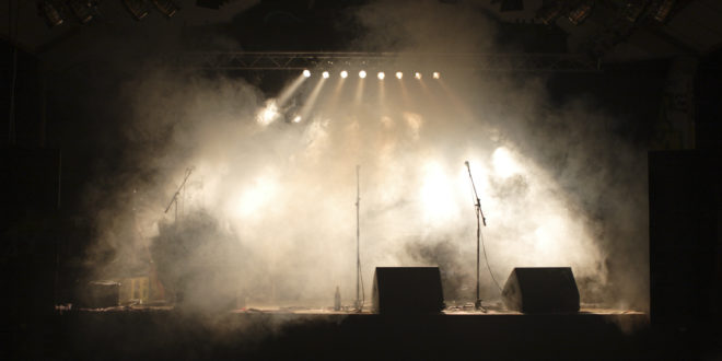 a stage with smoke and lights