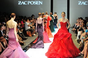 a group of women in dresses on a runway