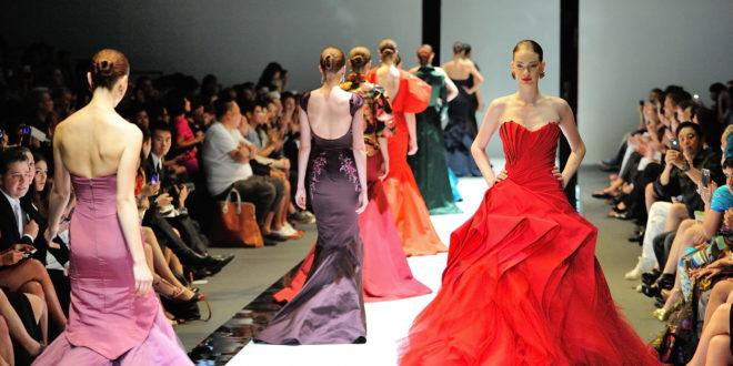 a group of women in dresses on a runway