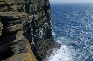 a cliff with a body of water