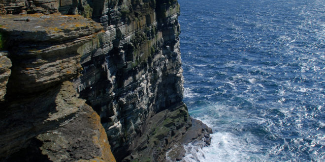 a cliff with a body of water
