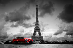 a red car in front of Eiffel Tower