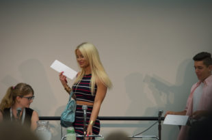 a woman holding a piece of paper