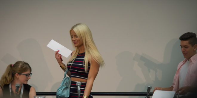 a woman holding a piece of paper