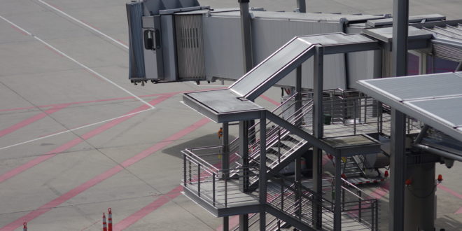 an airport with stairs and a walkway