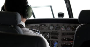 a man in a pilot's uniform in a cockpit