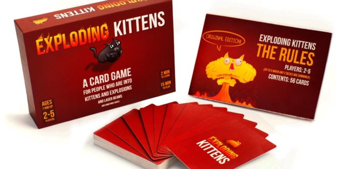 a red box with a stack of cards and a cat on it