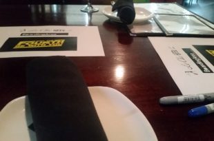 a table with papers and a pen on it